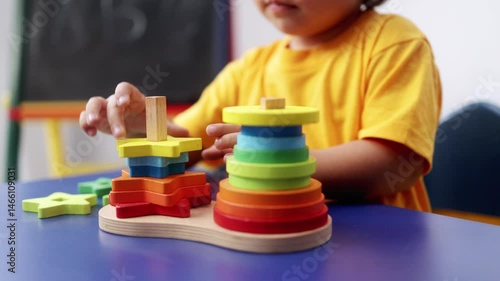 Child hands playing with didactic toys at preschool or daycare room. Education culture concept