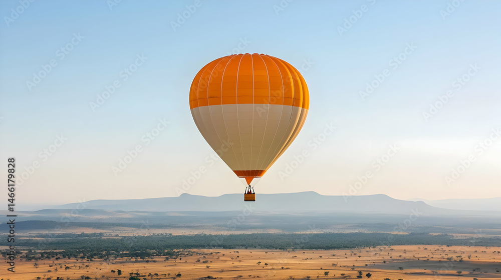 Obraz premium Orange And White Hot Air Balloon Over Desert Landscape