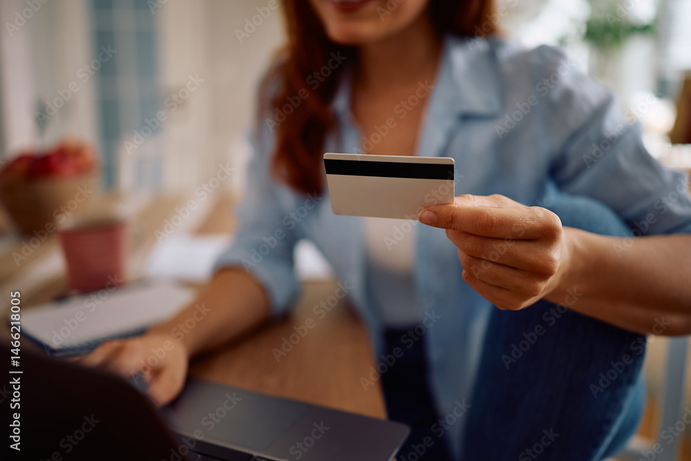 Close up of woman using credit card while home shopping. Close up of woman using credit card while home shopping.