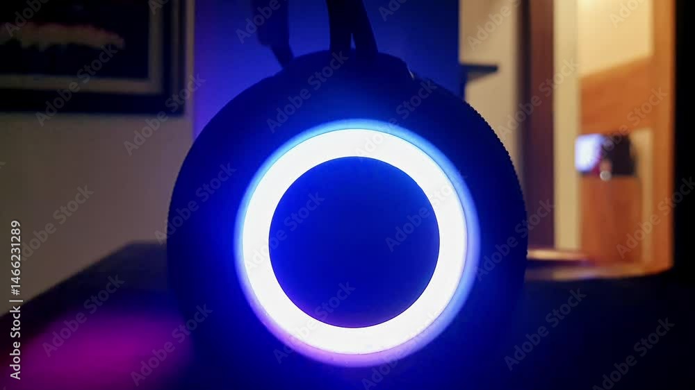 Close-up of a music speaker with multicolor LED lights blinking to the beats while playing music