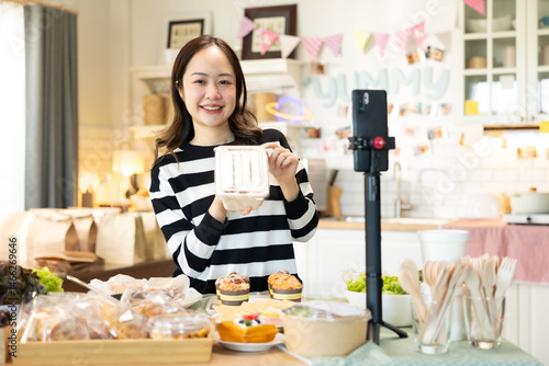 Small business owners are selling .Asian bakery  cake shop owner enjoy posting picture and review her cake on social media or online marketing streaming publish for advertising small business making m