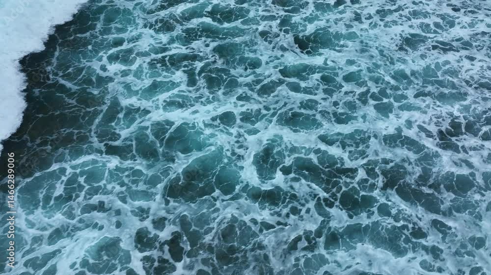 Aerial view of multiple surfers paddling and catching a breaking wave in the clear tropical waters off Mauritius Aerial view of multiple surfers paddling and catching a breaking wave in the clear tropical waters off Mauritius