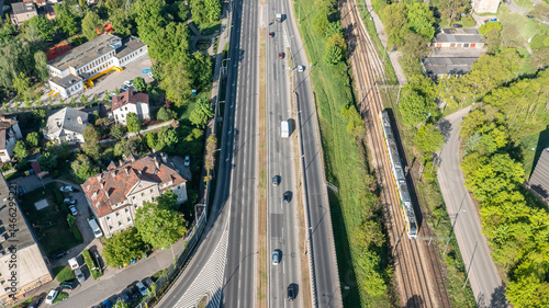 Slika na platnu Aerial vertical view of a multilane urban road with cars and adjacent railway, s