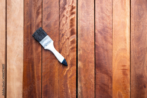 Tableau sur toile Paint brush apply varnish on lumber or wood product in top view