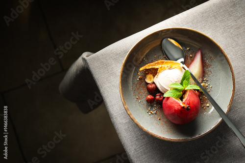 Obraz na płótnie Ice cream and pear in wine on plate and spoon on light background, space for text w salonie