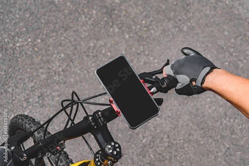Top view of a mobile phone on a bicycle handlebar.