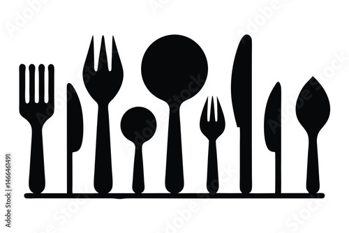 Kitchen utensils, including knives, forks, and spoons, are arranged in an orderly row
