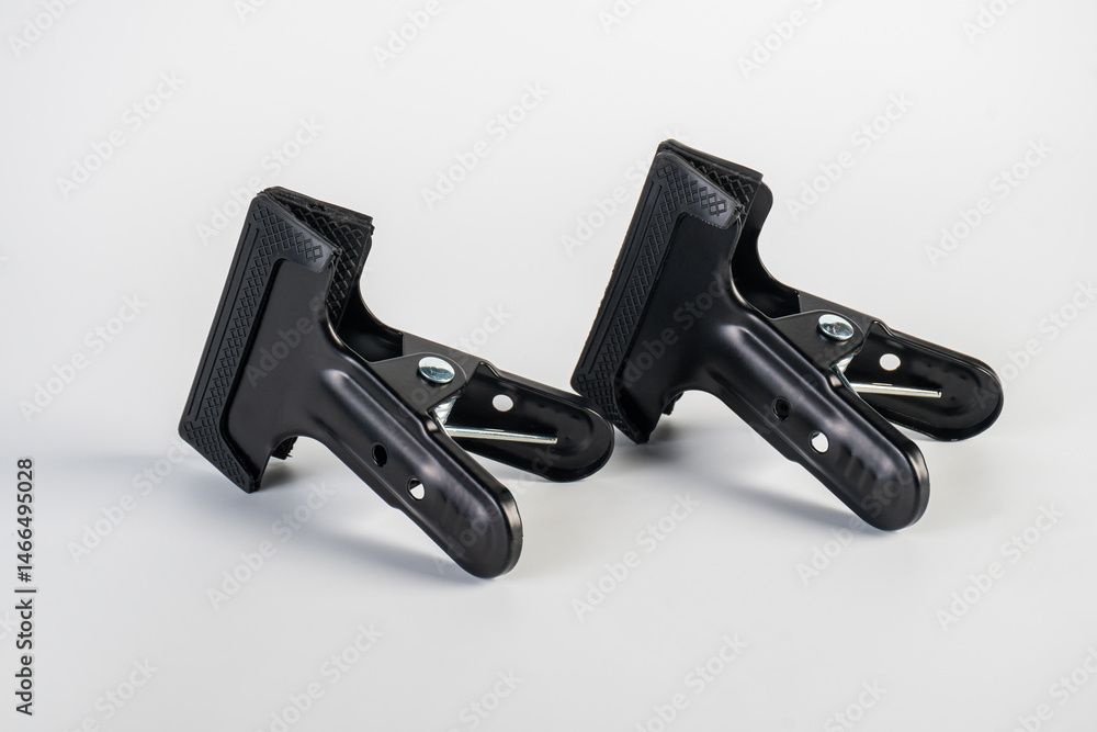 Obraz premium Black plastic spring clamp isolated on white background.