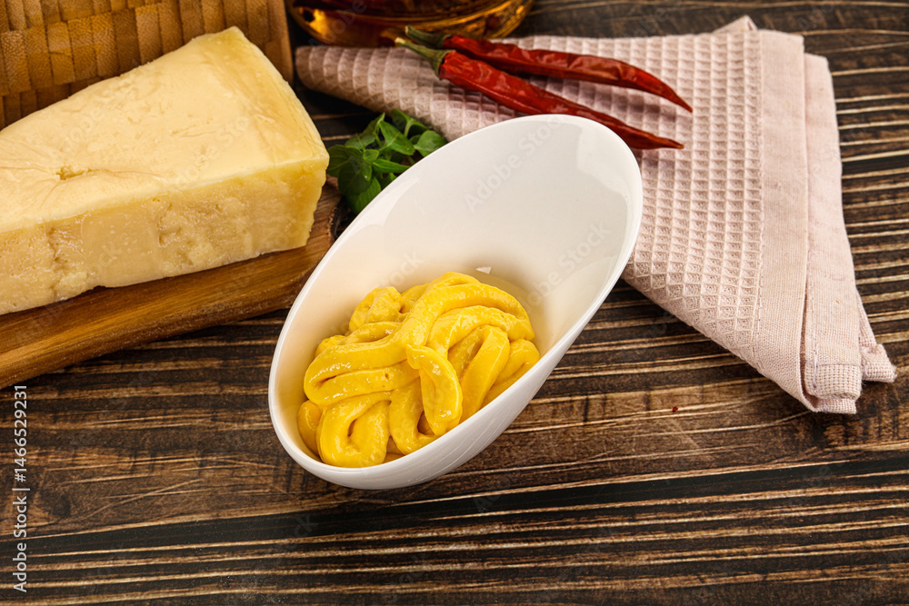 Yellow cheese sauce in the bowl