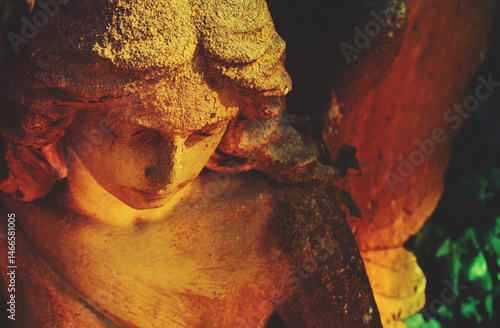 Sweet facial expression of angel. Fragment of an ancient statue. Close up.