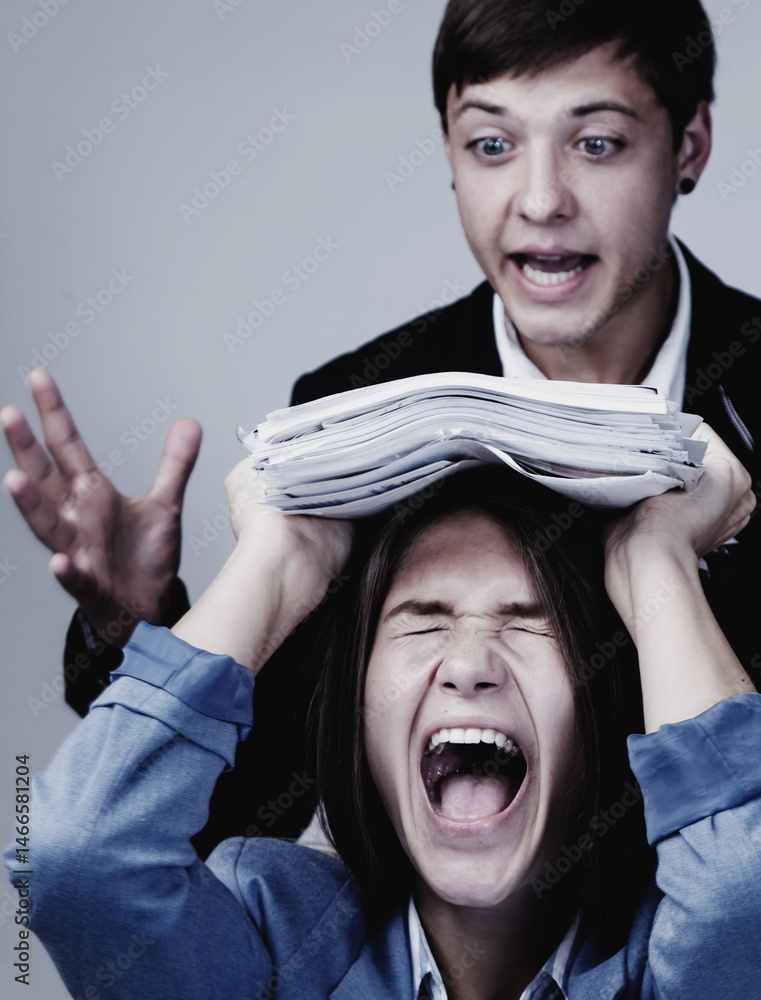 Angry boss angry on a new employee and she is shocked. Business, gender, subordination, conflict concept. Vertical image.