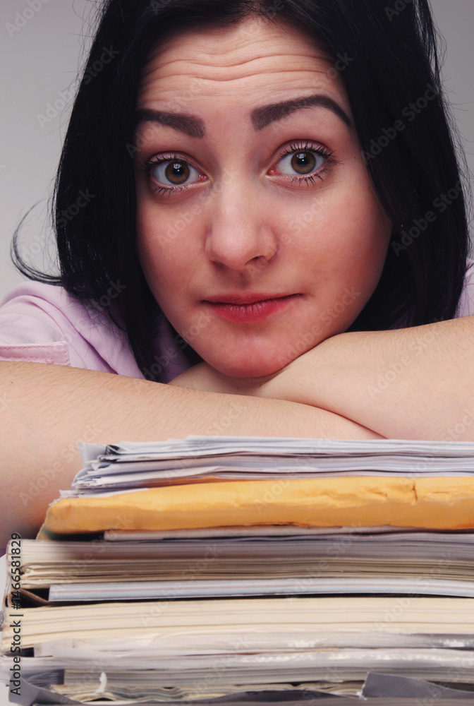 Tired and exhausted woman working with lot of documents.