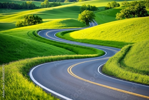 A winding road in the middle of a green field