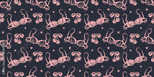 Wide seamless background with tender pink lingerie on stylish black background. Graphic wallpaper, flirty and fashionable packaging, textile design, or romantic feminine vibe with a rock gothic twist