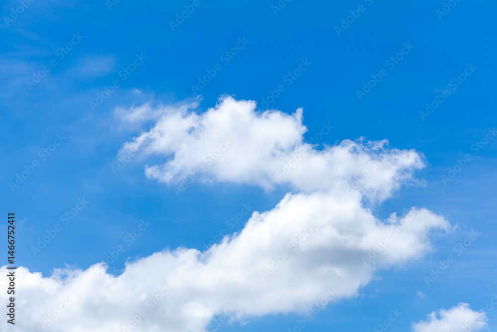 Fototapeta premium Bright blue sky with fluffy white clouds.