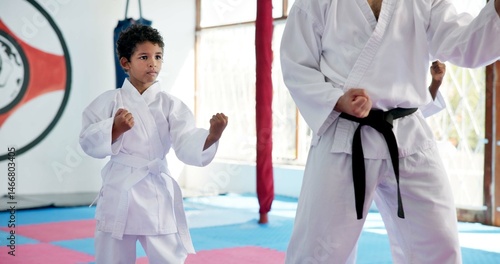 Boy, lesson and sensei with student in karate class, self defense pose or martial arts with youth for combat education. Taekwondo training, stance and instructor with male child for coaching in dojo