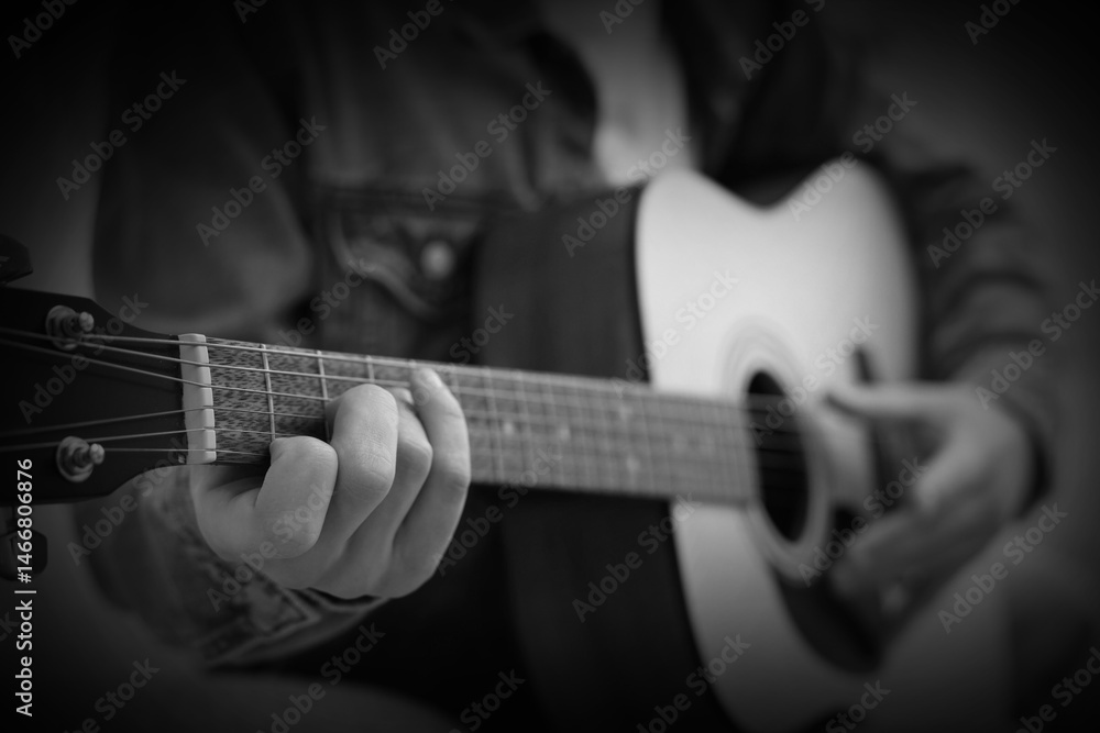 Fototapeta premium Man playing guitar, closeup. Black and white effect