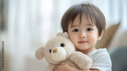 Happy Child Holding Soft Teddy Bear in Bright Indoor Setting