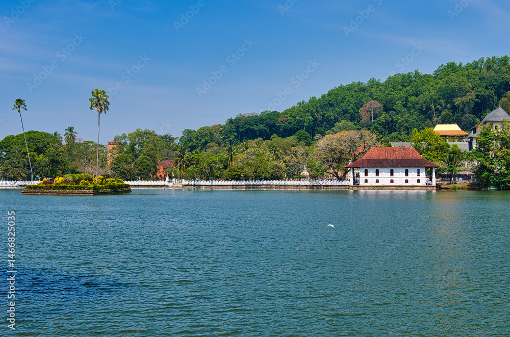 Obraz premium KANDY, SRI LANKA - FEBRUARY 10, 2021: View on Kandy lake and big Buddha on top of the hill. Kandy is home of The Temple of the Tooth Relic, one of the most sacred Buddhist places of worship. 