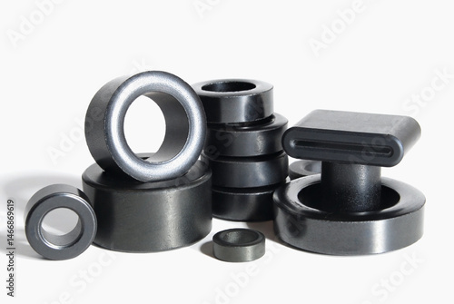 ferrite rings of various shapes and diameters on a white background