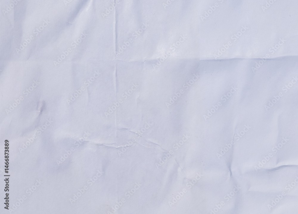 Fototapeta premium Distressed white paper with layered wrinkles and glue remnants, perfect for a vintage backdrop.