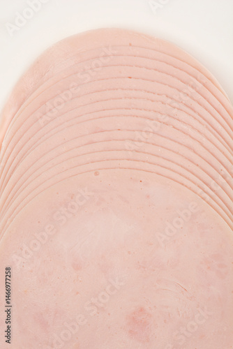Obraz na płótnie A close-up shot of a stack of thinly sliced chicken breast deli meat w salonie