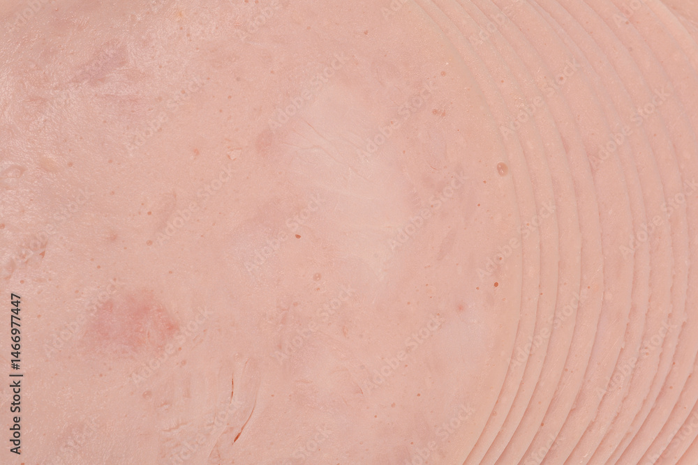 A close-up shot of a stack of thinly sliced chicken breast deli meat