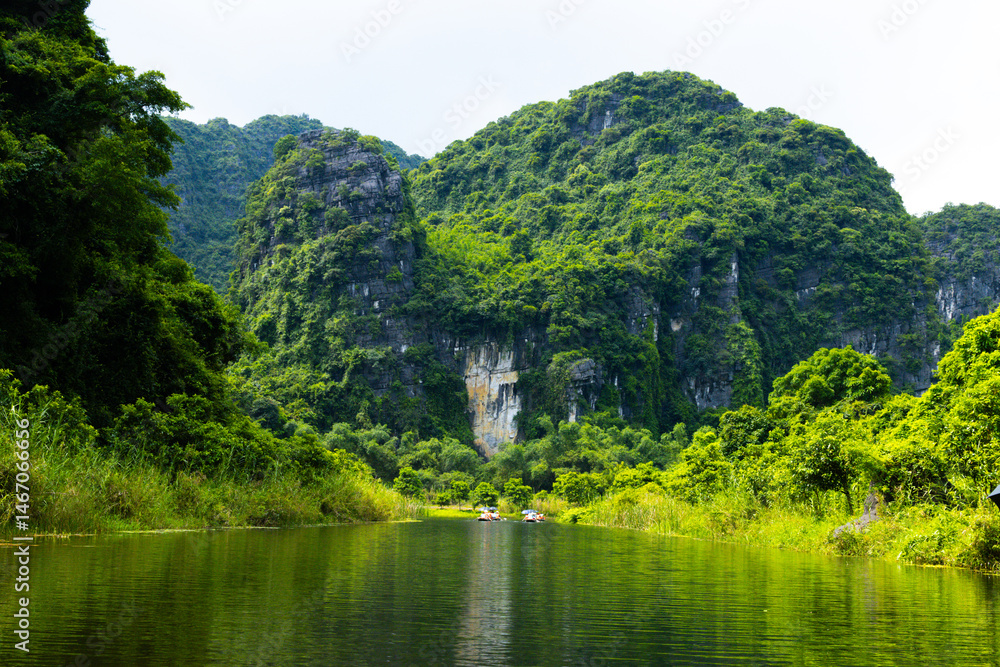 Fototapeta premium Ninh Binh, Vietnam - July 18, 2022 : Beautiful Natural Landscape In Trang An Landscape Complex Of Ninh Binh Province, Vietnam. Trang An Area Was Designated As A Dual UNESCO World Heritage Site.