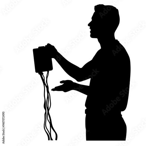 Man holding device with cables against plain background  