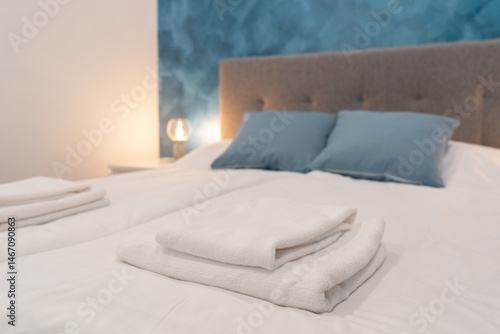 Clean white towels on bed at hotel room. Close-up. interior background. Towel in Hotel Room. Room service.