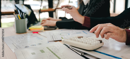 Wallpaper Mural Young colleagues discussing financial business and analysis Teamwork concept in modern office Calculate personal taxes for clients Torontodigital.ca