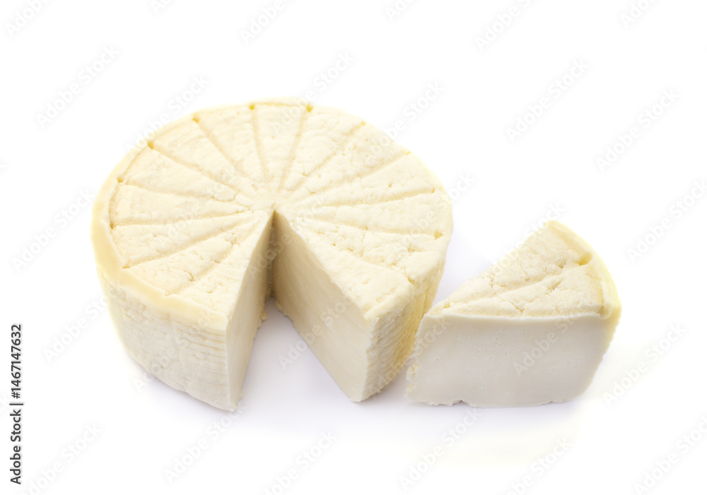 A head of homemade cheese and a cut piece. A head of homemade cheese and a cut piece.