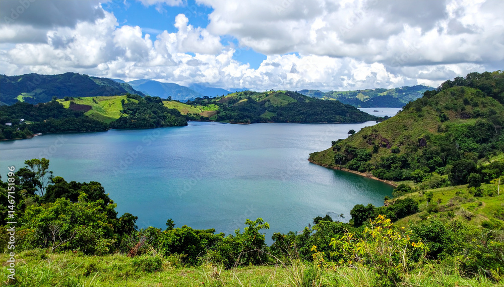 Panoramic view of a serene lake surrounded by green hills, capturing the peaceful natural landscapes of El Salvador. Panoramic view of a serene lake surrounded by green hills, capturing the peaceful natural landscapes of El Salvador.