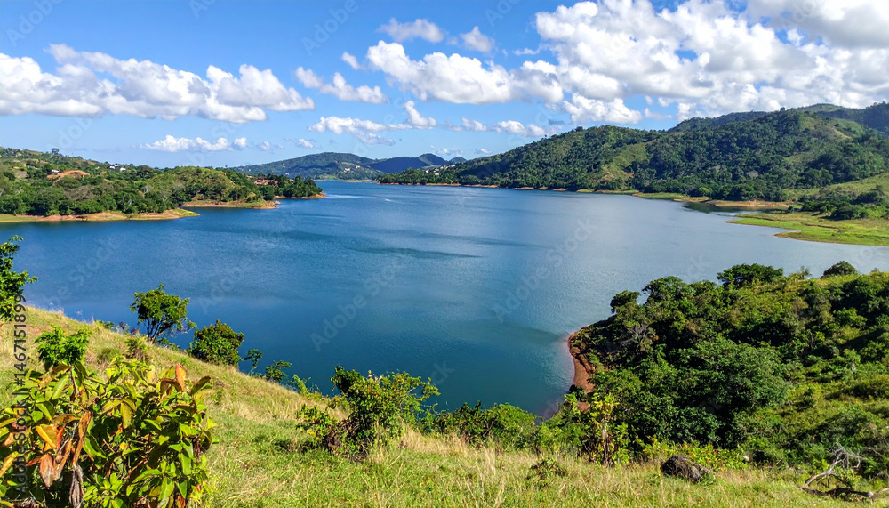 Panoramic view of a serene lake surrounded by green hills, capturing the peaceful natural landscapes of El Salvador. Panoramic view of a serene lake surrounded by green hills, capturing the peaceful natural landscapes of El Salvador.