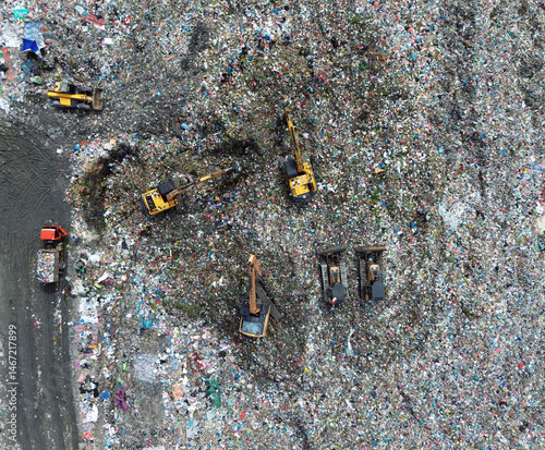 Billede på lærred Aerial top view of excavators working on a landfill site in Medan, Indonesia – N