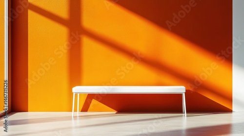 White bench against an orange wall with sunlight shadows.