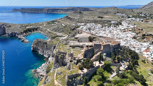 Obraz na płótnie Aerial drone photo of stunning traditional village and medieval archaeological site of Acropolis of Lindos overlooking main beach and Saint Paul's bay, Rhodos island, Dodecanese, Greece w salonie