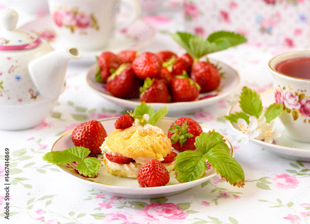 Cream puffs cakes or profiterole filled with whipped cream and strawberries Cream puffs cakes or profiterole filled with whipped cream and strawberries