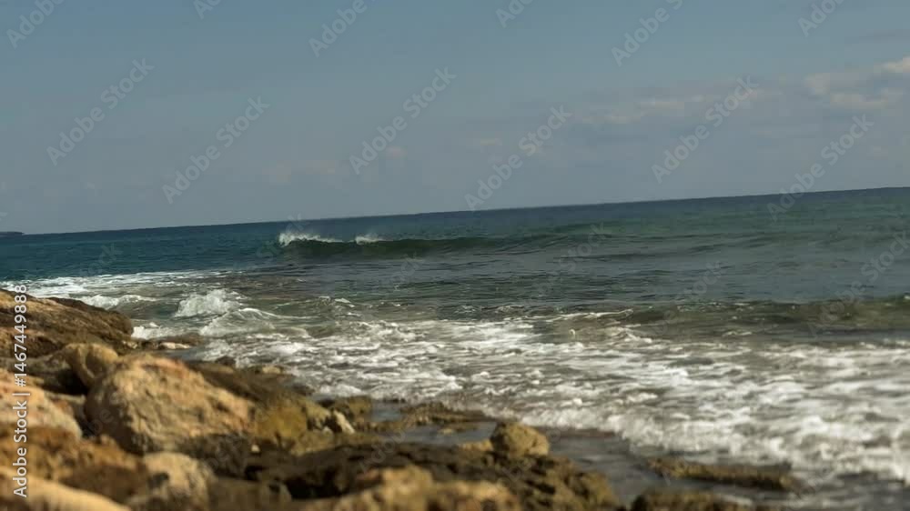 Natural rocky outcrop along a Cypriot coastline with soft waves and clear skies, creating a peaceful seascape. Natural rocky outcrop along a Cypriot coastline with soft waves and clear skies, creating a peaceful seascape.