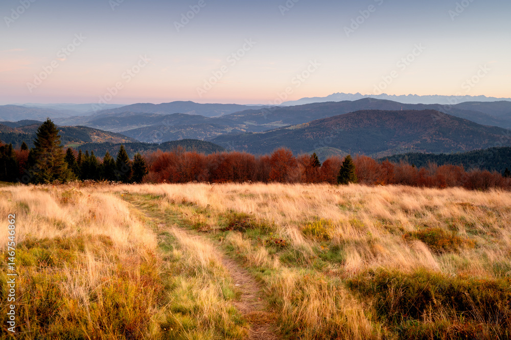 Autumn landscape of the Polish mountains. Picturesque meadow Stumorgowa, Beskids, Poland. Tatra Mountains in the background. Autumn landscape of the Polish mountains. Picturesque meadow Stumorgowa, Beskids, Poland. Tatra Mountains in the background.