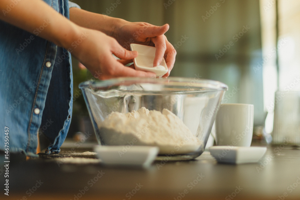 Fototapeta premium Cooking homemade pizza. Female hands making dough, adding sauce and ingredients.