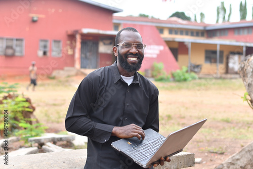 focused african man working on his laptop outdoor