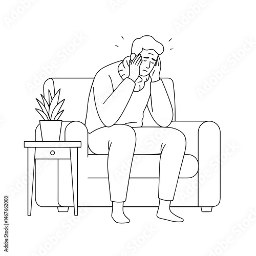 Man feeling stressed while sitting on a couch at home  