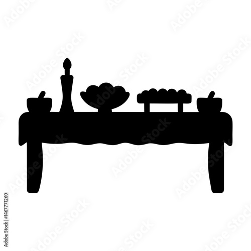 A silhouette of a table laden with bowls, a vase, and baked goods