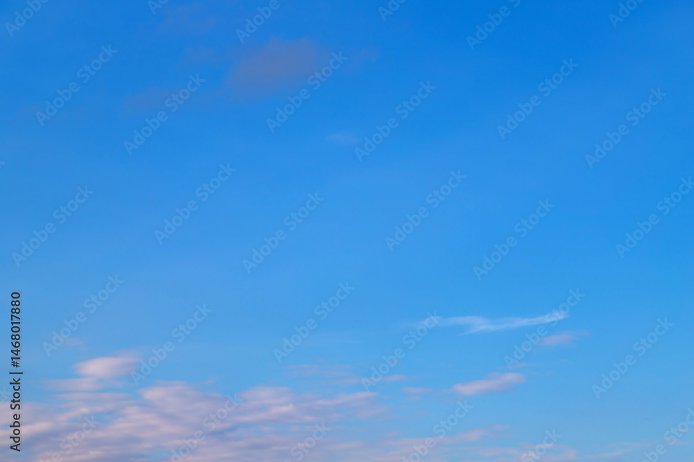 Bright blue sky with gentle clouds captured during a clear day
