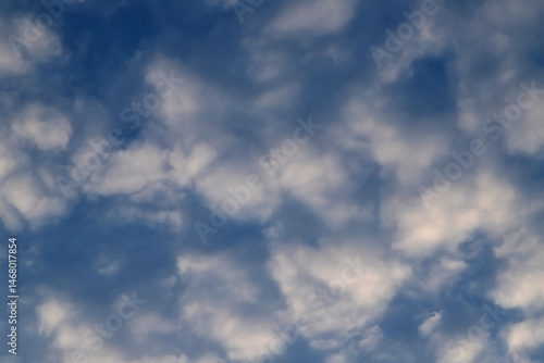 Soft white clouds in a tranquil blue sky