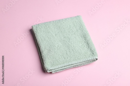 Clean towel on pink background, above view