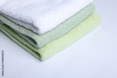 Stack of clean towels on white background, closeup