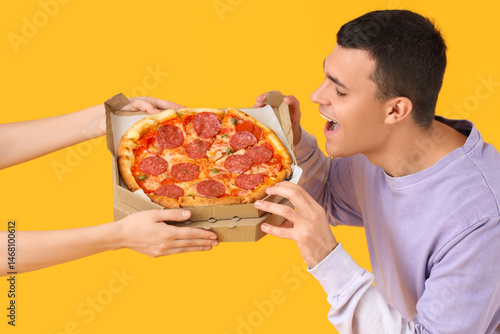 Young man taking tasty pepp...