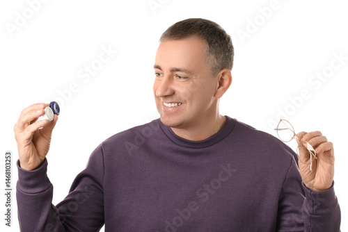 Happy mature man with contact lens case and eyeglasses on white background